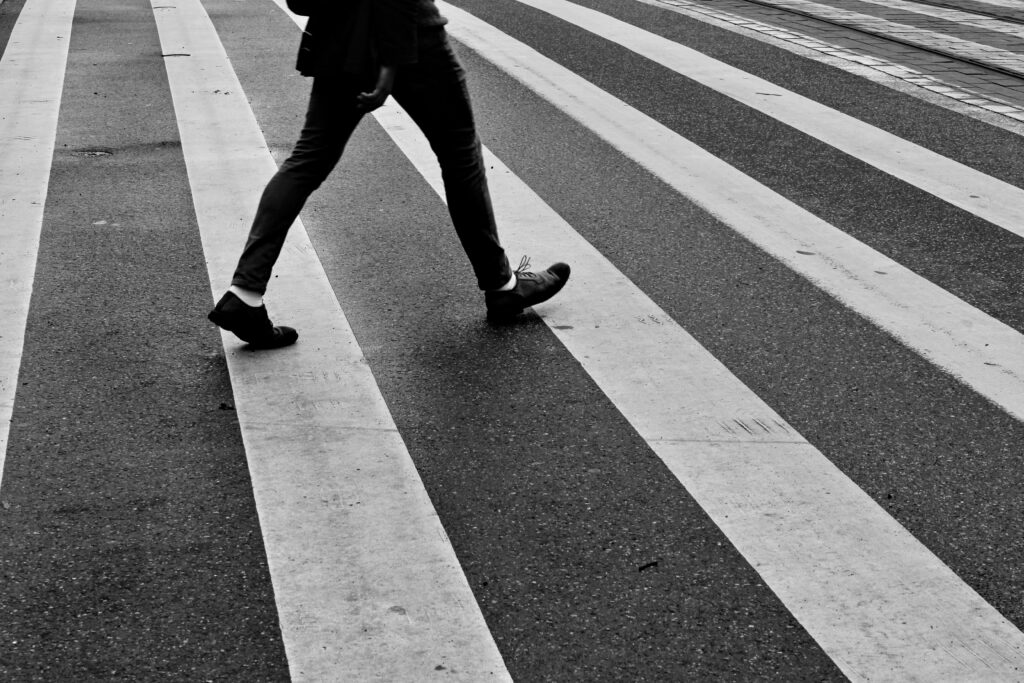 A person walking across a crosswalk