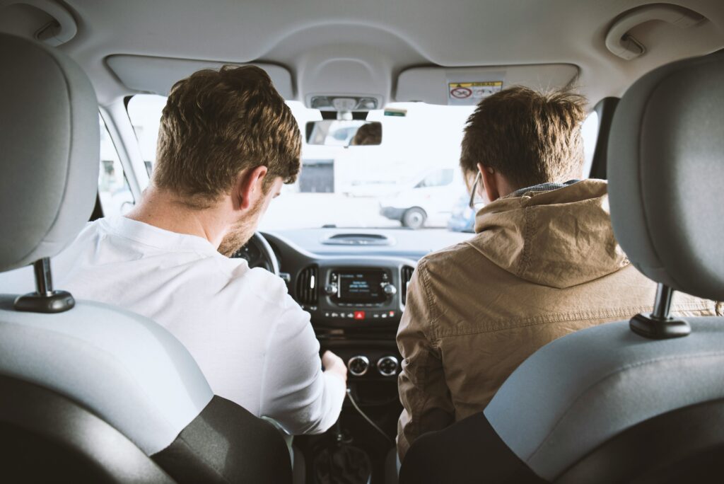 Two passengers in the back seat of a rideshare vehicle