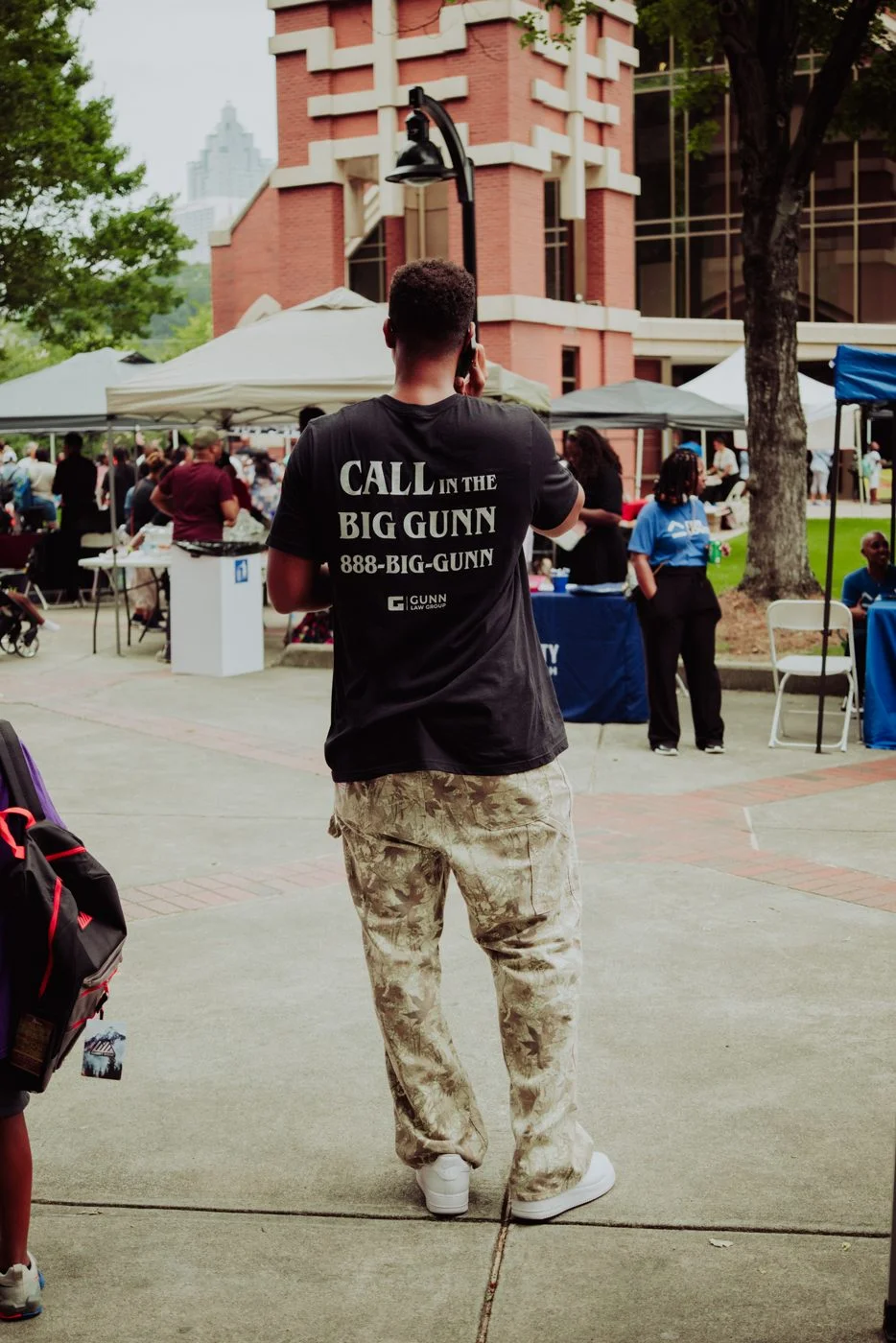 Gunn Law Group team member in a Call the Big Gunn shirt at the Ebenezer community expo